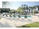 Community pool with lounge chairs and surrounding greenery at 500 River Oaks Dr. # 58I, Myrtle Beach, SC 29579