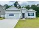 Charming single-story home with white siding, blue door, and well-manicured lawn. MOVE IN NOW! at 368 Clear Lake Dr., Conway, SC 29526