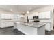Bright kitchen features white cabinets, gray granite countertops, stainless steel appliances and large island at 368 Clear Lake Dr., Conway, SC 29526