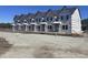 New townhome construction featuring multiple units with gray roofs and visible framing at 6876 Watertower Rd. # 102, Longs, SC 29568