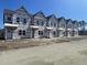 A block of newly constructed townhomes with neat architectural lines in a developing neighborhood at 6876 Watertower Rd. # 104, Longs, SC 29568