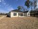 Back exterior of new home showing siding, black roof, screened in porch and sodded yard at 1033 Sioux Swamp Dr., Conway, SC 29527