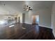 Open-concept living room and kitchen area with dark wood floors and modern light fixtures at 1033 Sioux Swamp Dr., Conway, SC 29527