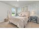 Bright bedroom with patterned wallpaper, queen bed, and stylish nightstands at 3865 Lady Bug Dr., Shallotte, NC 28470