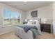 Bedroom with striped bedding, nightstands, and large window at 3865 Lady Bug Dr., Shallotte, NC 28470