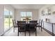 Dining area with dark wood table and access to the backyard at 3865 Lady Bug Dr., Shallotte, NC 28470