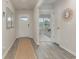 Light-filled entryway with wood-look floors and a view into another room at 3865 Lady Bug Dr., Shallotte, NC 28470