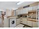 Functional kitchen with a combination washer/dryer and a breakfast bar overlooking the dining area at 4719 S Ocean Blvd. # 209, North Myrtle Beach, SC 29582