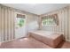 Bathroom with built-in bathtub and window at 1492 Fox Hollow Way, North Myrtle Beach, SC 29582