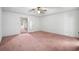 Spacious bedroom with ceiling fan and pink carpet at 1492 Fox Hollow Way, North Myrtle Beach, SC 29582