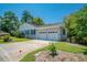 Two-car garage with driveway and mature trees at 1492 Fox Hollow Way, North Myrtle Beach, SC 29582