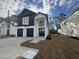 Two-story black and white home featuring a two-car garage, modern design, and appealing architectural details at 2247 Sand Dunes Dr., Myrtle Beach, SC 29577