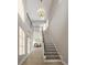 Bright hallway with staircase featuring wood treads, modern railing, and a decorative chandelier fixture at 2247 Sand Dunes Dr., Myrtle Beach, SC 29577