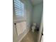 Cozy bathroom with window, featuring neutral paint, tiled floors, toilet, and towel rack at 590 Collins Ave., Murrells Inlet, SC 29576
