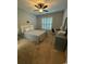 Neutral bedroom featuring a ceiling fan, large window with plantation shutters and carpet at 590 Collins Ave., Murrells Inlet, SC 29576