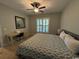 Spacious bedroom featuring a ceiling fan, plantation shutters, neutral paint, and a desk area at 590 Collins Ave., Murrells Inlet, SC 29576