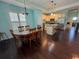 Dining room open to kitchen with lots of light, wood floors, and breakfast bar at 590 Collins Ave., Murrells Inlet, SC 29576