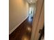 Hallway featuring hard wood floors that lead to a door with natural light shining through at 590 Collins Ave., Murrells Inlet, SC 29576