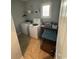 Functional laundry room with white washer, dryer, wire shelving and tiled floors at 590 Collins Ave., Murrells Inlet, SC 29576