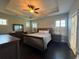 Spacious main bedroom with a ceiling fan and wood furniture at 590 Collins Ave., Murrells Inlet, SC 29576