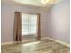 Spacious bedroom with light purple walls and wood-look flooring at 105 Willow Ridge Rd., Myrtle Beach, SC 29588