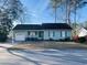 One-story house with green siding, attached garage, and a well-maintained lawn at 105 Willow Ridge Rd., Myrtle Beach, SC 29588