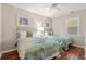 Bright bedroom featuring two beds with floral quilts, ceiling fan and wood floors at 601 Hillside Dr. N # 2903, North Myrtle Beach, SC 29582