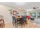 Cozy dining area with a wooden table, black chairs, stylish chandelier, and an adjacent living room at 601 Hillside Dr. N # 2903, North Myrtle Beach, SC 29582