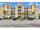 Inviting condo building with multiple balconies, palm trees, manicured landscaping, and ample parking at 601 Hillside Dr. N # 2903, North Myrtle Beach, SC 29582