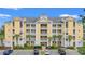 Exterior shot of condo building with a bright yellow facade, balconies and well-maintained landscaping at 601 Hillside Dr. N # 2903, North Myrtle Beach, SC 29582