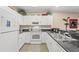 Well-maintained kitchen featuring granite countertops, white cabinets, and modern appliances at 601 Hillside Dr. N # 2903, North Myrtle Beach, SC 29582