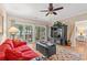 Bright living room featuring hardwood floors, a red sofa, and sliding doors to the outside patio space at 601 Hillside Dr. N # 2903, North Myrtle Beach, SC 29582