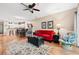 Open living space with a red sofa, accent chairs, hardwood floors, and seamless flow into the dining area at 601 Hillside Dr. N # 2903, North Myrtle Beach, SC 29582
