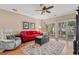 Comfortable living room featuring a red sofa, decorative rug, ceiling fan, and access to the outdoor patio at 601 Hillside Dr. N # 2903, North Myrtle Beach, SC 29582