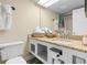 Bathroom features granite countertop, white cabinets, toilet, and a mirror at 1207 S Ocean Blvd. # 20808, Myrtle Beach, SC 29577
