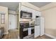 Compact kitchenette equipped with stainless steel appliances and white cabinetry at 1207 S Ocean Blvd. # 20808, Myrtle Beach, SC 29577