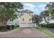 Two-story yellow house with double garage and paved driveway at 1335 Hidden Harbor Rd., Myrtle Beach, SC 29577