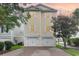 Two-story yellow house with double garage and paved driveway at 1335 Hidden Harbor Rd., Myrtle Beach, SC 29577