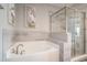 Inviting bathroom featuring a soaking tub and a glass-enclosed shower, offering a spa-like experience at 1907 S Waccamaw Dr., Garden City Beach, SC 29576