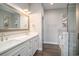 Modern bathroom with double vanity sinks, marble countertops, and a glass-enclosed shower at 1907 S Waccamaw Dr., Garden City Beach, SC 29576