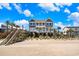 Gorgeous beach home with palm trees and wooden walkway to the beach at 1907 S Waccamaw Dr., Garden City Beach, SC 29576