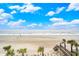 Scenic beach view with palm trees and walkway leading to a sandy shoreline at 1907 S Waccamaw Dr., Garden City Beach, SC 29576
