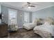 Comfortable bedroom with twin beds, neutral decor, and dark wood-look flooring at 1907 S Waccamaw Dr., Garden City Beach, SC 29576