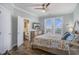 Bright bedroom with decorative bedspread, ceiling fan and natural light from the windows at 1907 S Waccamaw Dr., Garden City Beach, SC 29576