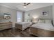 Inviting bedroom with twin beds, dark wood-look flooring and soft, neutral decor at 1907 S Waccamaw Dr., Garden City Beach, SC 29576