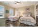 Bedroom features two beds, neutral decor, and a window bringing in natural light at 1907 S Waccamaw Dr., Garden City Beach, SC 29576