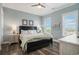 Comfortable bedroom with a dark wood bed frame, and views of the beach at 1907 S Waccamaw Dr., Garden City Beach, SC 29576