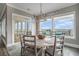 Dining area with a rustic table set and large windows offering stunning views of the ocean at 1907 S Waccamaw Dr., Garden City Beach, SC 29576