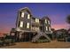 Stunning raised beach home featuring dual staircases, ample parking, and coastal charm at 1907 S Waccamaw Dr., Garden City Beach, SC 29576