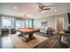 Spacious game room with pool table, seating, and access to an ocean view balcony at 1907 S Waccamaw Dr., Garden City Beach, SC 29576